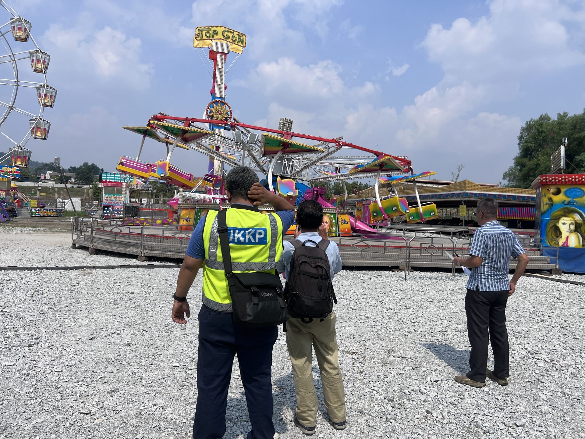 Inspection personnel viewing Top Gun ride setup