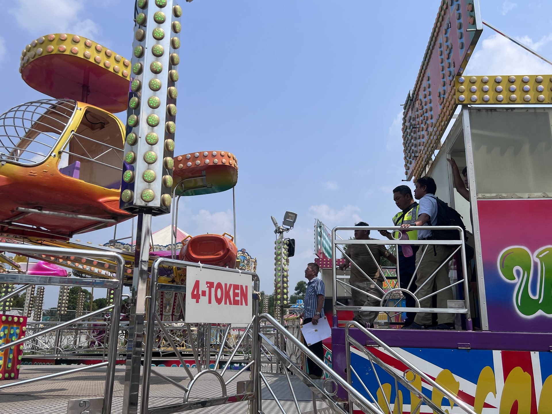 Inspection personnel reviewing ride platform and access area
